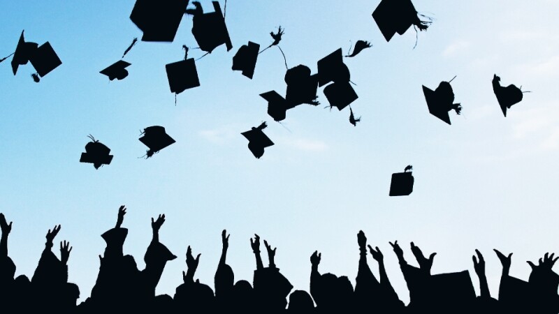 Students throwing their graduation caps in the air